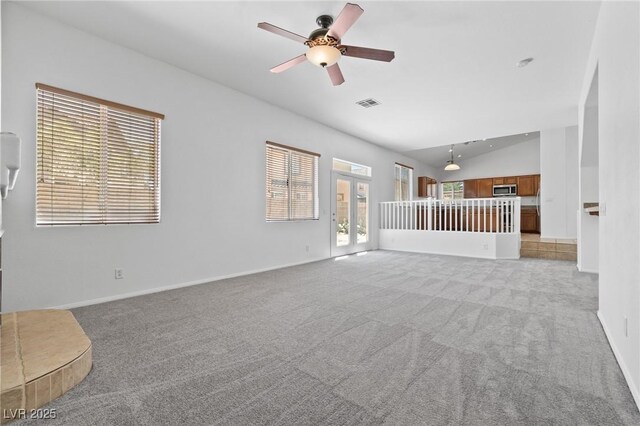 3273 Alcudia Bay Ave, Las Vegas, NV 89141 - unfurnished living room with lofted ceiling, light colored carpet, a ceiling fan, and baseboards