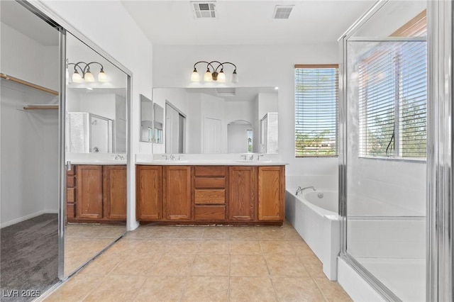 3273 Alcudia Bay Ave, Las Vegas, NV 89141 - full bathroom featuring double vanity, a bath, a shower stall, and tile patterned floors