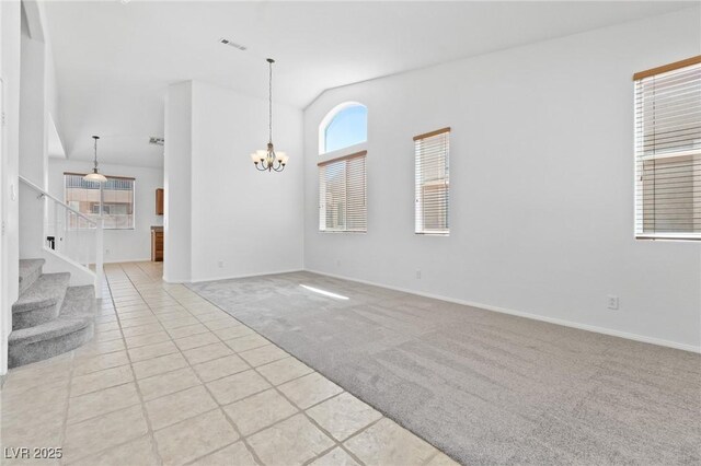 3273 Alcudia Bay Ave, Las Vegas, NV 89141 - unfurnished living room featuring light colored carpet, plenty of natural light, a chandelier, vaulted ceiling, and light tile patterned flooring