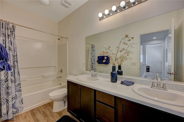 5244 Fiery Sky Ridge St, Las Vegas, NV 89148 - bathroom featuring double vanity, shower / bath combination with curtain, toilet, and wood finished floors