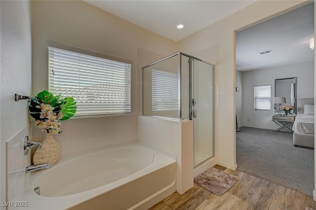 5244 Fiery Sky Ridge St, Las Vegas, NV 89148 - bathroom featuring a bath, a stall shower, baseboards, and wood finished floors