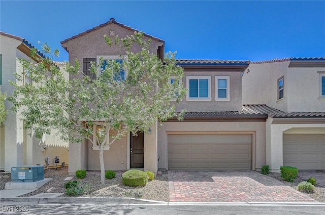 5244 Fiery Sky Ridge St, Las Vegas, NV 89148 - view of front of house with a tiled roof, a garage, stucco siding, and decorative driveway