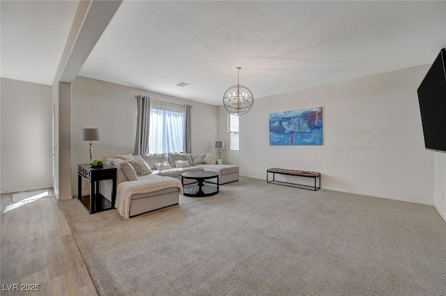 5244 Fiery Sky Ridge St, Las Vegas, NV 89148 - living room featuring a chandelier, baseboards, and wood finished floors