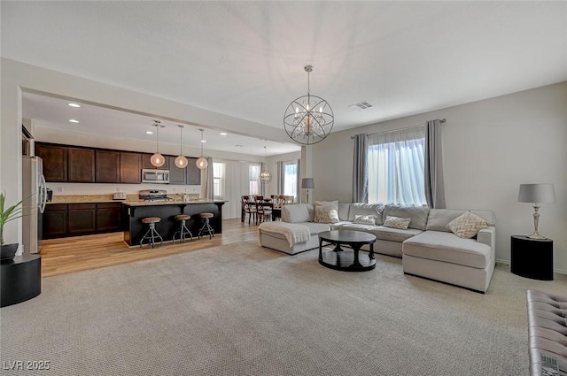 5244 Fiery Sky Ridge St, Las Vegas, NV 89148 - living area featuring a chandelier, recessed lighting, and light colored carpet