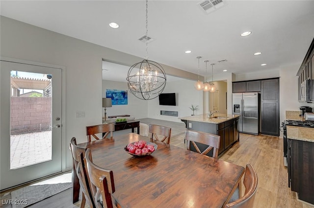 5244 Fiery Sky Ridge St, Las Vegas, NV 89148 - dining area featuring light wood-style floors, a chandelier, and recessed lighting