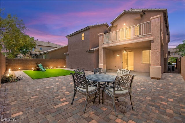 11274 Civita St, Las Vegas, NV 89141 - view of patio featuring a balcony, outdoor dining area, a playground, and ceiling fan