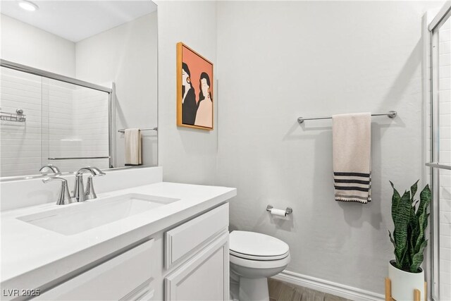 7350 N Decatur Blvd Unit 5, Las Vegas, NV 89131 - full bathroom with vanity, toilet, tiled shower, wood finished floors, and baseboards