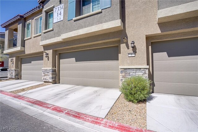 7350 N Decatur Blvd Unit 5, Las Vegas, NV 89131 - view of front facade featuring stone siding, stucco siding, and a garage
