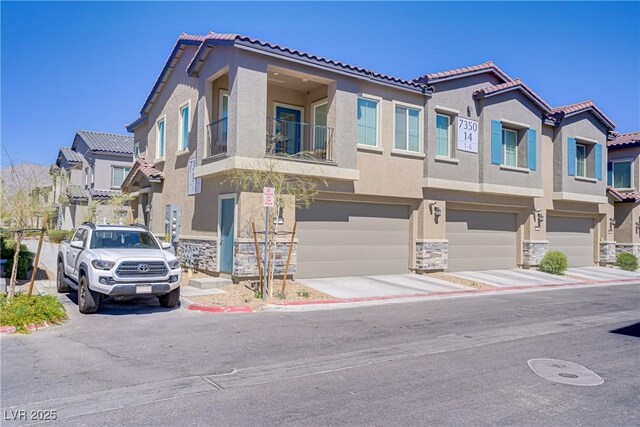 7350 N Decatur Blvd Unit 5, Las Vegas, NV 89131 - townhome / multi-family property featuring stone siding, a garage, stucco siding, and a residential view