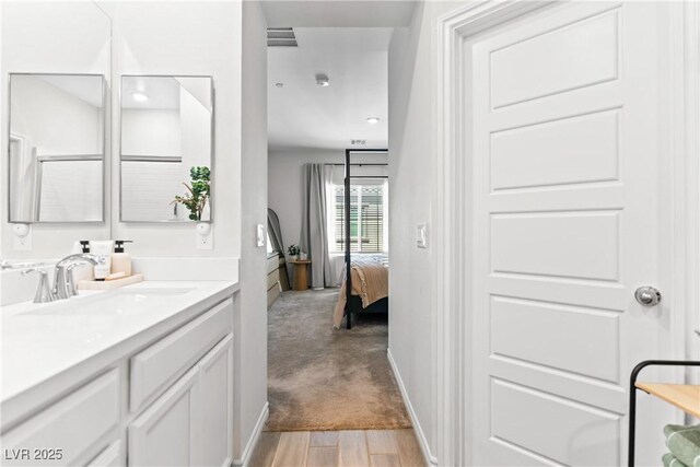 7350 N Decatur Blvd Unit 5, Las Vegas, NV 89131 - bathroom with vanity, ensuite bathroom, and wood finished floors