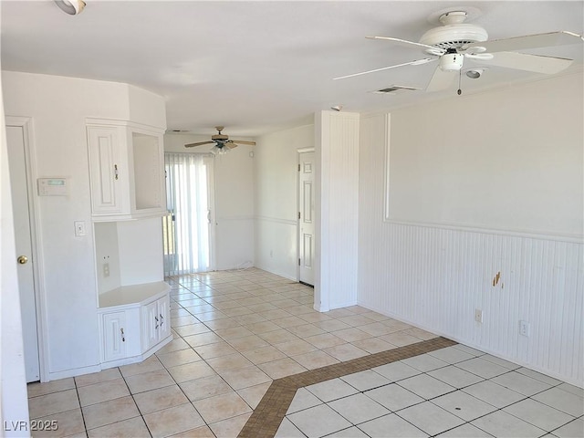 129 Maple St, Henderson, NV 89015 - spare room featuring ceiling fan, light tile patterned floors, and wainscoting