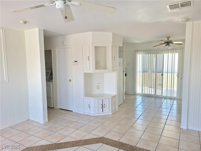 129 Maple St, Henderson, NV 89015 - unfurnished room featuring ceiling fan, light tile patterned floors, washer / clothes dryer, and baseboards