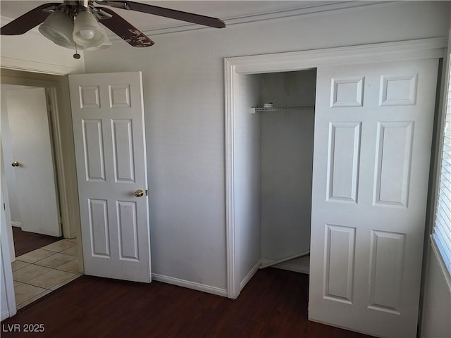 129 Maple St, Henderson, NV 89015 - unfurnished bedroom with dark wood-type flooring, a closet, baseboards, and a ceiling fan