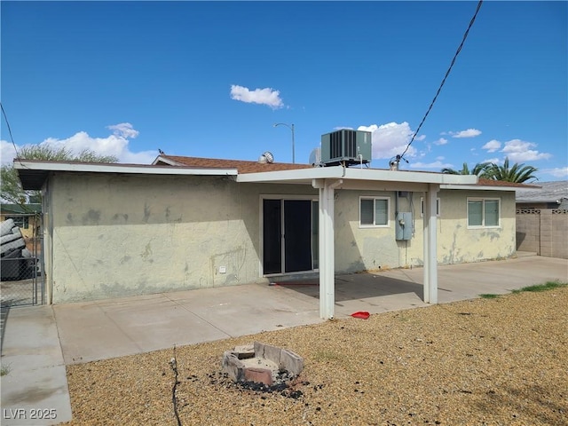 129 Maple St, Henderson, NV 89015 - rear view of property featuring stucco siding, cooling unit, and a patio