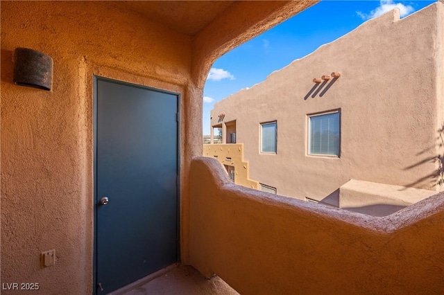728 Hardy Way Unit E, Mesquite, NV 89027 - entrance to property with a balcony and stucco siding
