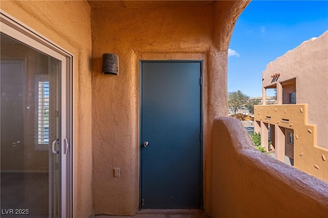 728 Hardy Way Unit E, Mesquite, NV 89027 - doorway to property with a balcony and stucco siding