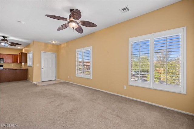 728 Hardy Way Unit E, Mesquite, NV 89027 - unfurnished living room with a ceiling fan, light carpet, and baseboards