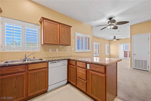728 Hardy Way Unit E, Mesquite, NV 89027 - kitchen featuring white dishwasher, a sink, a peninsula, brown cabinets, and a ceiling fan