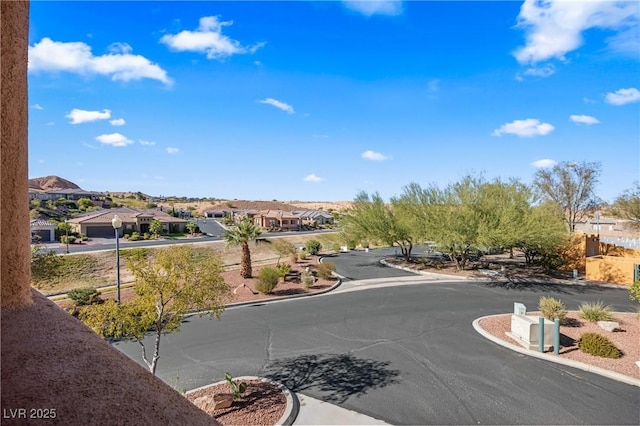 728 Hardy Way Unit E, Mesquite, NV 89027 - view of asphalt street featuring a residential view, street lighting, and curbs