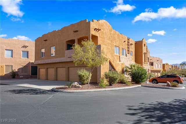 728 Hardy Way Unit E, Mesquite, NV 89027 - view of property with an attached garage, a residential view, and driveway