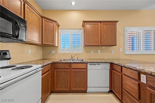 728 Hardy Way Unit E, Mesquite, NV 89027 - kitchen with white appliances, a sink, brown cabinetry, and recessed lighting