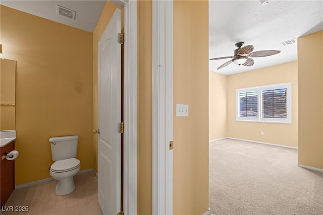728 Hardy Way Unit E, Mesquite, NV 89027 - bathroom featuring vanity, toilet, ceiling fan, and baseboards