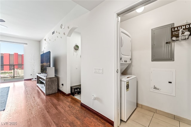 200 W Sahara Ave Unit 3303, Las Vegas, NV 89102 - laundry area featuring electric panel, stacked washer and clothes dryer, arched walkways, and baseboards