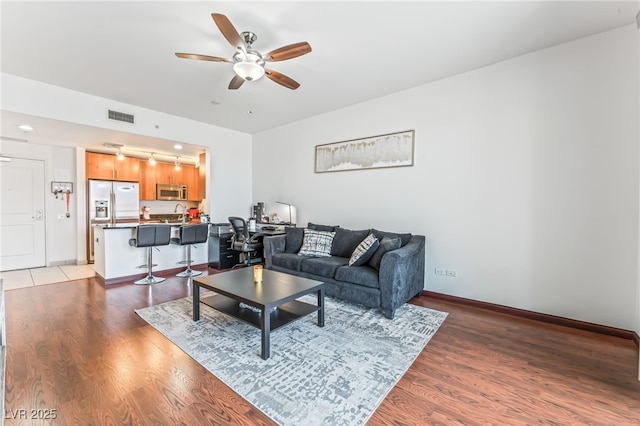 200 W Sahara Ave Unit 3303, Las Vegas, NV 89102 - living area featuring a ceiling fan, light wood-style flooring, and baseboards