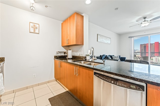 200 W Sahara Ave Unit 3303, Las Vegas, NV 89102 - kitchen with dishwasher, a sink, dark stone counters, a ceiling fan, and light tile patterned floors