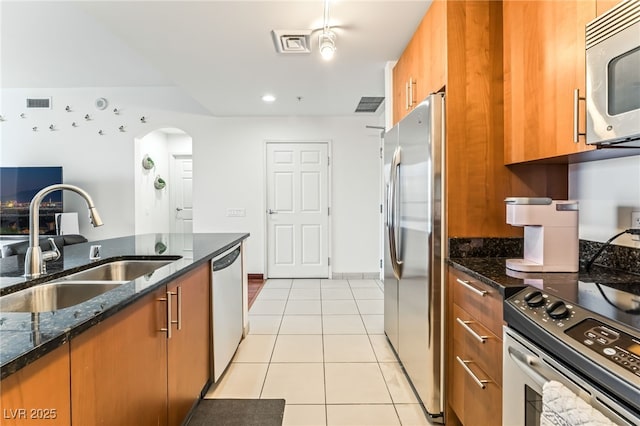 200 W Sahara Ave Unit 3303, Las Vegas, NV 89102 - kitchen with appliances with stainless steel finishes, a sink, brown cabinets, and light tile patterned floors
