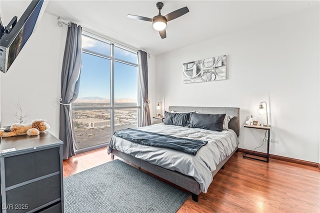 200 W Sahara Ave Unit 3303, Las Vegas, NV 89102 - bedroom with wood finished floors, floor to ceiling windows, a ceiling fan, baseboards, and access to outside