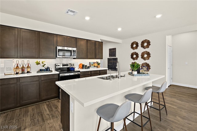 4350 E Brusca Way, Pahrump, NV 89061 - kitchen with stainless steel appliances, a sink, dark wood-type flooring, light countertops, and recessed lighting