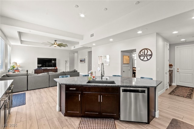 245 Hull St, Henderson, NV 89015 - kitchen with stainless steel dishwasher, a sink, light wood finished floors, light stone countertops, and recessed lighting