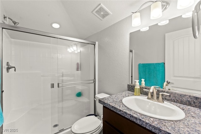 245 Hull St, Henderson, NV 89015 - full bathroom with a textured wall, a stall shower, vanity, toilet, and vaulted ceiling