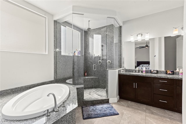 245 Hull St, Henderson, NV 89015 - bathroom featuring a shower stall, a garden tub, vanity, ceiling fan, and tile patterned flooring