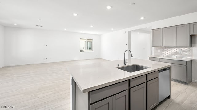 4450 E Brusca Ct, Pahrump, NV 89061 - kitchen featuring gray cabinetry, stainless steel dishwasher, recessed lighting, light wood-style flooring, and a center island with sink