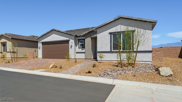 4450 E Brusca Ct, Pahrump, NV 89061 - ranch-style home with driveway, an attached garage, stucco siding, and a tiled roof