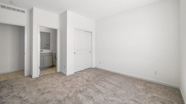 4450 E Brusca Ct, Pahrump, NV 89061 - unfurnished bedroom with light carpet and ensuite bathroom