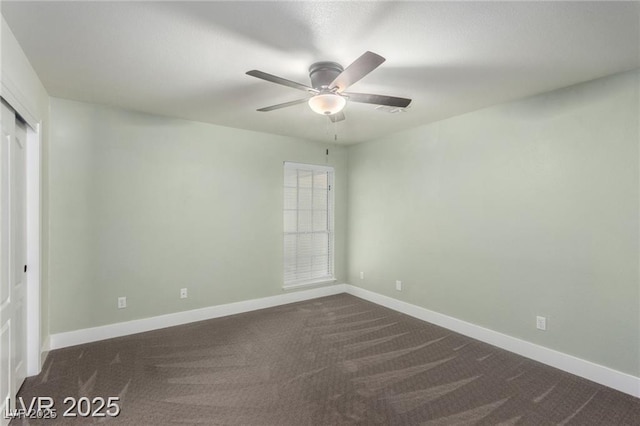 10058 Saint Augustine St, Las Vegas, NV 89183 - unfurnished bedroom featuring dark colored carpet, baseboards, a closet, and a ceiling fan