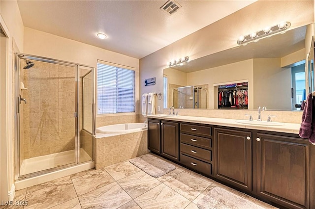 2285 Moresca Ave, Henderson, NV 89052 - bathroom featuring a bath, a stall shower, double vanity, and a spacious closet