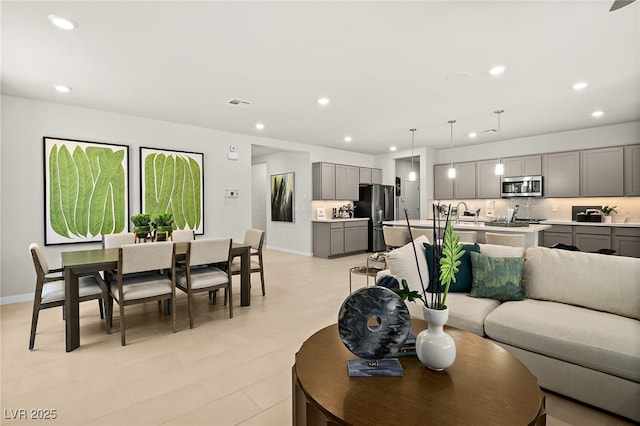 4365 E Brusca Way, Pahrump, NV 89061 - living room featuring baseboards, recessed lighting, and light tile patterned floors