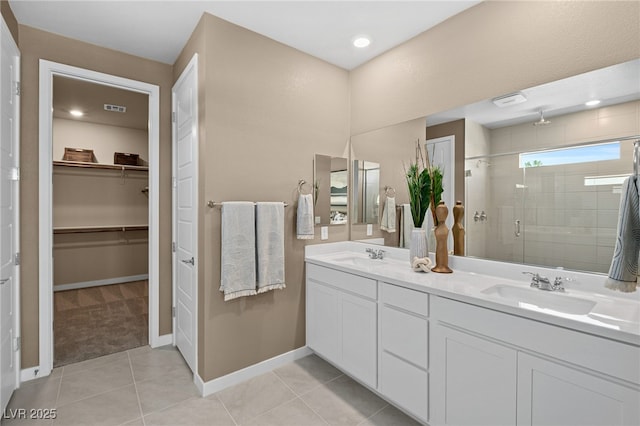 4365 E Murlo Rd, Pahrump, NV 89061 - full bath with a stall shower, double vanity, a spacious closet, baseboards, and tile patterned flooring