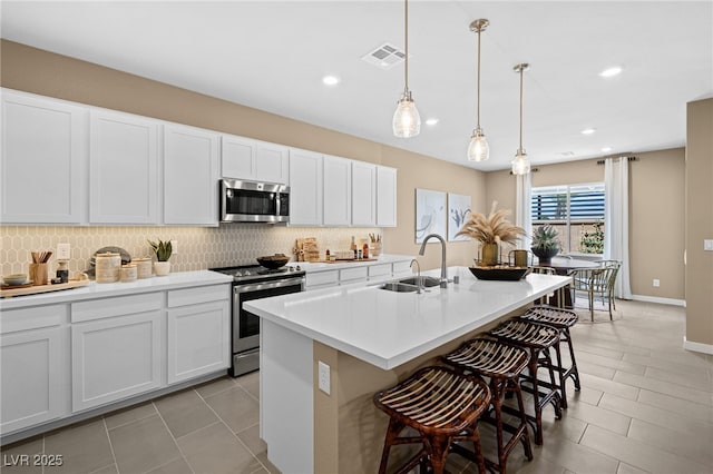 4365 E Murlo Rd, Pahrump, NV 89061 - kitchen featuring appliances with stainless steel finishes, a sink, decorative backsplash, a kitchen breakfast bar, and recessed lighting