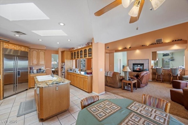 1105 Malachite Ct, Henderson, NV 89011 - kitchen featuring stainless steel appliances, a sink, open floor plan, light tile patterned flooring, and a center island with sink