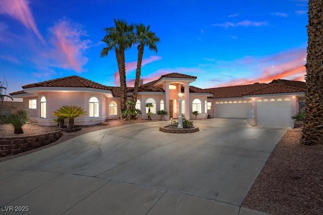 1105 Malachite Ct, Henderson, NV 89011 - mediterranean / spanish-style house with concrete driveway, a garage, a tiled roof, and stucco siding