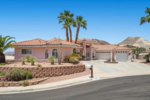 1105 Malachite Ct, Henderson, NV 89011 - mediterranean / spanish house featuring a garage, stucco siding, driveway, and a tile roof