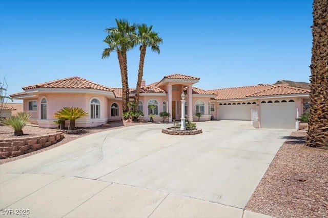 1105 Malachite Ct, Henderson, NV 89011 - mediterranean / spanish-style house featuring an attached garage, concrete driveway, stucco siding, and a tiled roof