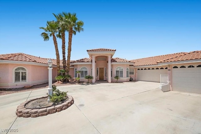 1105 Malachite Ct, Henderson, NV 89011 - mediterranean / spanish-style home with driveway, a garage, stucco siding, and a tile roof