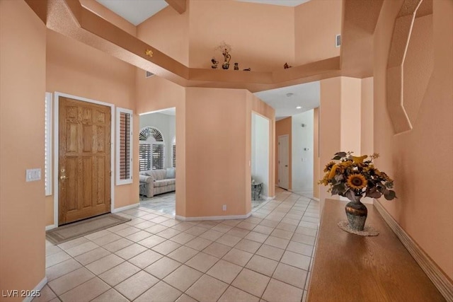 1105 Malachite Ct, Henderson, NV 89011 - entryway with light tile patterned floors, a high ceiling, and baseboards
