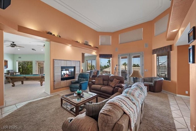 1105 Malachite Ct, Henderson, NV 89011 - carpeted living room featuring tile patterned floors, billiards, a fireplace, a high ceiling, and baseboards